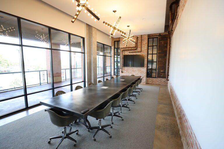 Luxury boardroom featuring industrial finishes and copper piping